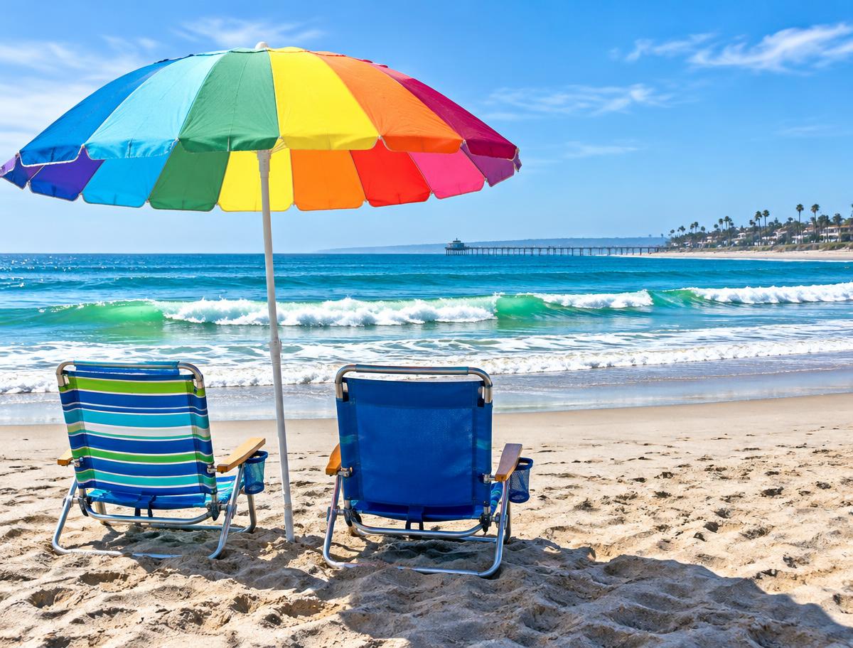 Beach chairs and a colorful umbrella beside the ocean